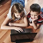 Children playing games in laptop.