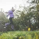 kid jumping in field